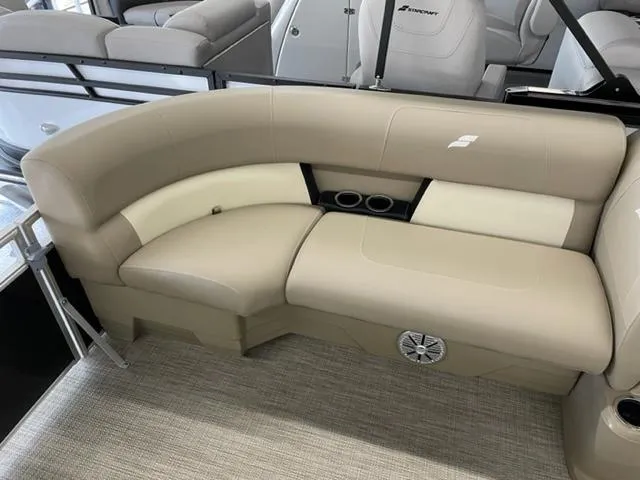 Slide: The Image of 2023 Starcraft LX 16 R boat interior with beige seating and cup holders. - 7