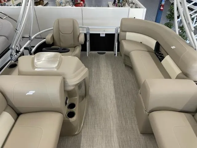 Slide: The Image of 2023 Starcraft LX 16 R pontoon boat interior with beige seating and helm. - 8