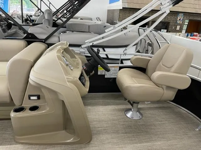 Slide: The Image of 2023 Starcraft LX 16 R boat interior with beige captain's chair and steering console. - 9