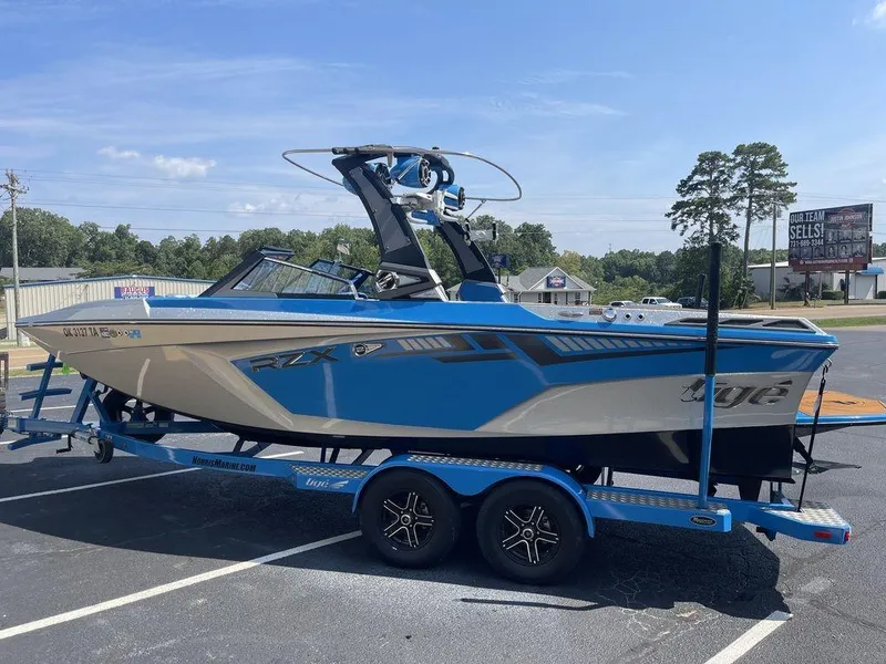 Slide: The Image of 2017 Tigé RZX2 boat in blue and gray on a matching trailer. - 7