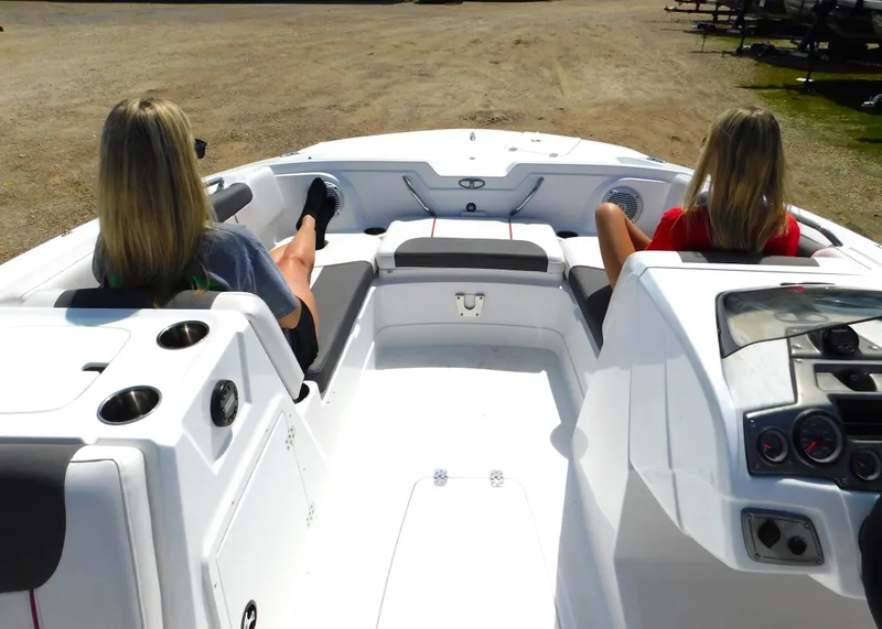 Slide: The Image of Two people relaxing on a 2023 Tahoe 1950 boat. - 11