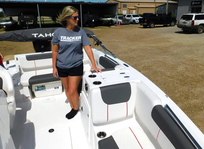 Slide: The Image of Woman standing on a 2023 Tahoe 1950 boat in a parking lot. - 14