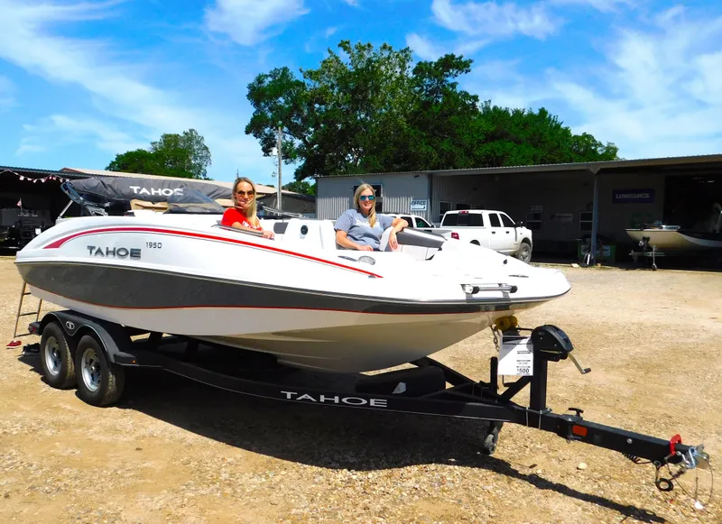 Slide: The Image of Two people on a 2023 Tahoe 1950 boat on a trailer. - 22