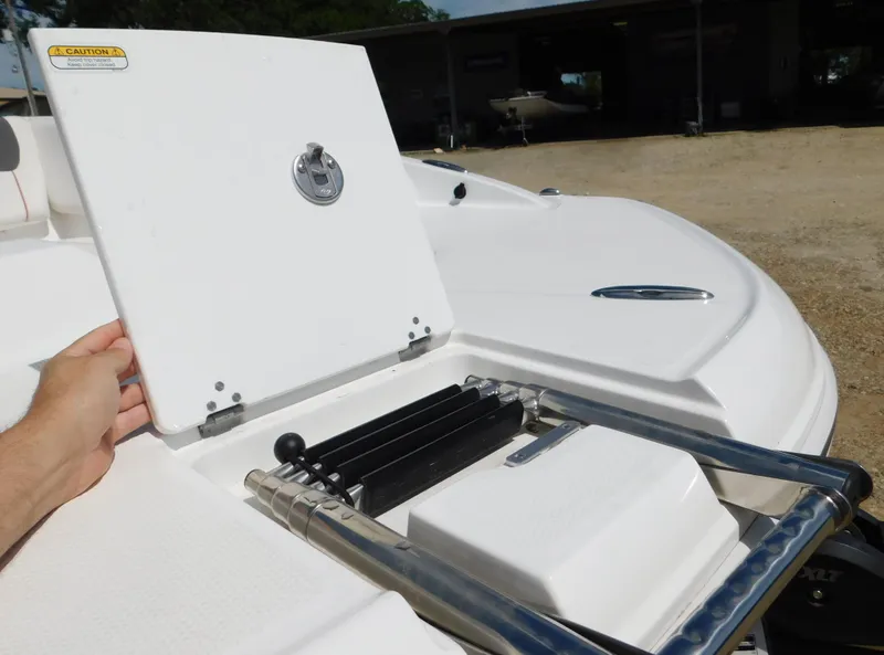 Slide: The Image of 2023 Tahoe 1950 boat with open storage compartment and ladder. - 26