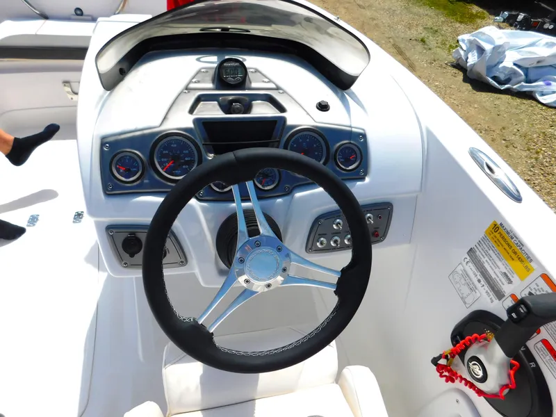 Slide: The Image of Steering console of a 2023 Tahoe 1950 boat with gauges and controls. - 31