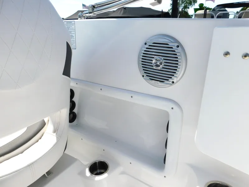 Slide: The Image of Interior of a 2023 Tahoe 1950 boat featuring a speaker and storage compartment. - 32
