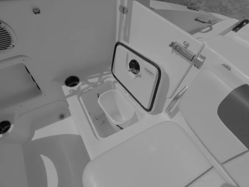 Slide: The Image of Interior of a 2023 Tahoe 1950 boat showing storage compartment and seating area. - 33