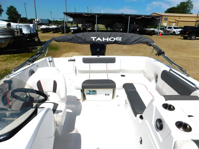 Slide: The Image of 2023 Tahoe 1950 boat interior with seating and steering wheel. - 35