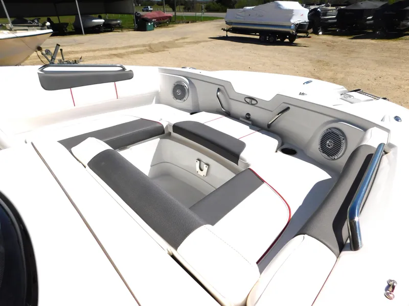 Slide: The Image of 2023 Tahoe 1950 boat interior with white and gray seating, speakers, and storage compartments. - 6