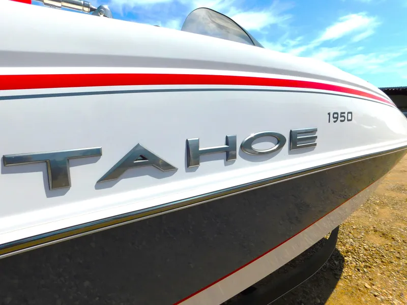 Slide: The Image of Close-up of 2023 Tahoe 1950 boat with logo and red stripe. - 9