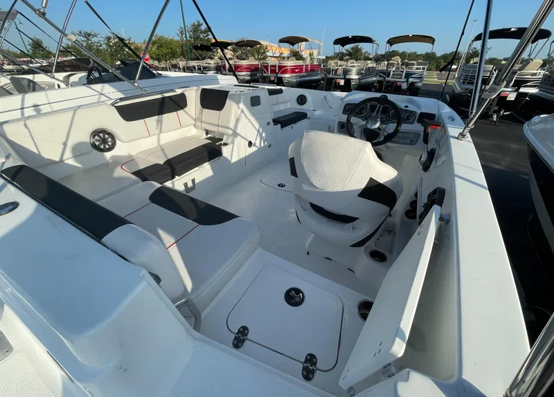 Slide: The Image of 2023 Tahoe 1950 boat interior with white seating and steering console. - 4