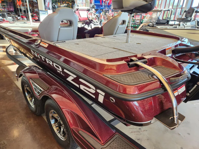 Slide: The Image of 2023 Nitro Z21 XL boat, maroon finish, displayed indoors. - 5