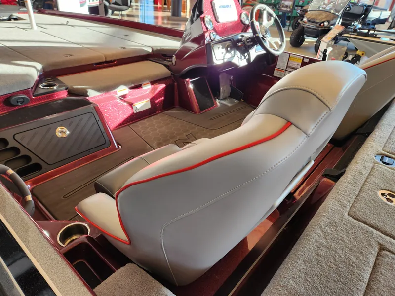 Slide: The Image of 2023 Nitro Z21 XL boat interior with gray and red seating, steering wheel, and dashboard. - 6