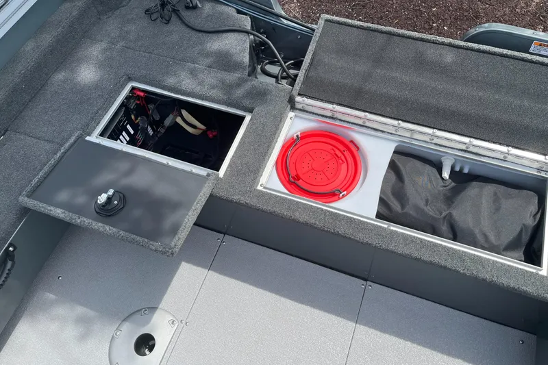 Slide: The Image of 2023 Starcraft Storm 166 DC boat storage compartments and battery access. - 11