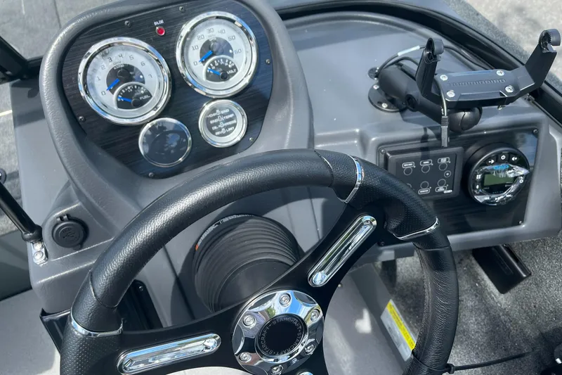 Slide: The Image of 2023 Starcraft Storm 166 DC boat dashboard with steering wheel and instrument panel. - 7
