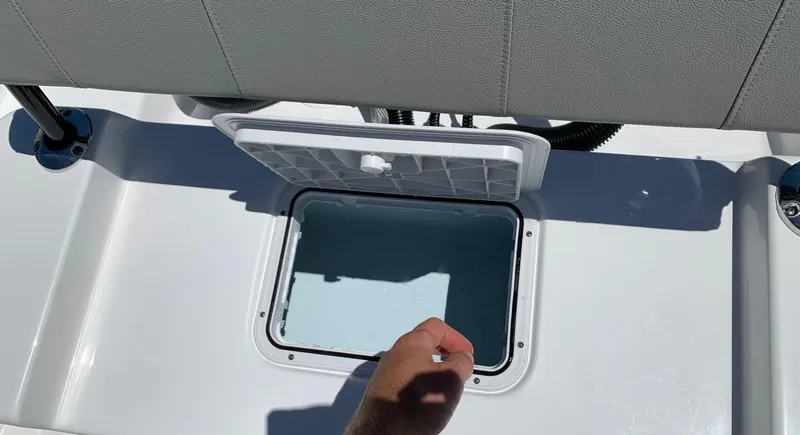 Slide: The Image of 2024 Cape Horn 24 XS boat storage compartment with open lid. - 17
