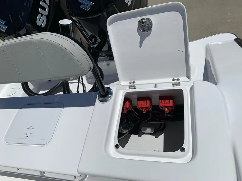 Slide: The Image of 2024 Cape Horn 24 XS boat with open battery compartment and dual Suzuki engines. - 18
