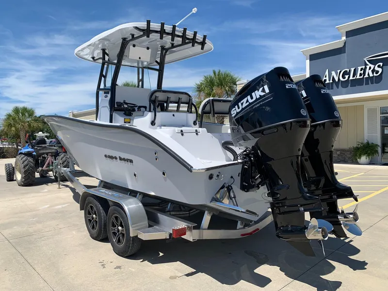 Slide: The Image of 2024 Cape Horn 24 XS boat with dual Suzuki engines on a trailer. - 2