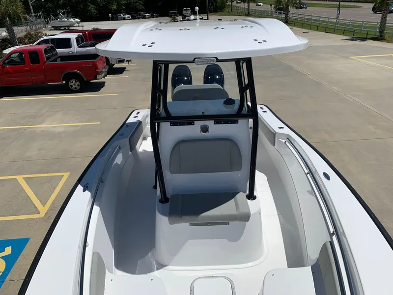 Slide: The Image of 2024 Cape Horn 24 XS boat in a parking lot, showcasing its spacious deck and seating. - 5