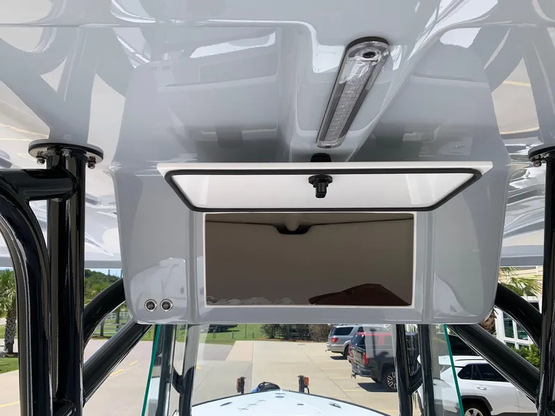 Slide: The Image of 2024 Cape Horn 24 XS boat console with storage compartment and overhead light. - 8