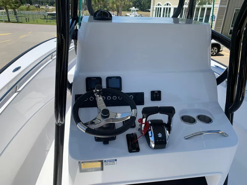 Slide: The Image of 2024 Cape Horn 24 XS boat console with steering wheel and controls. - 10