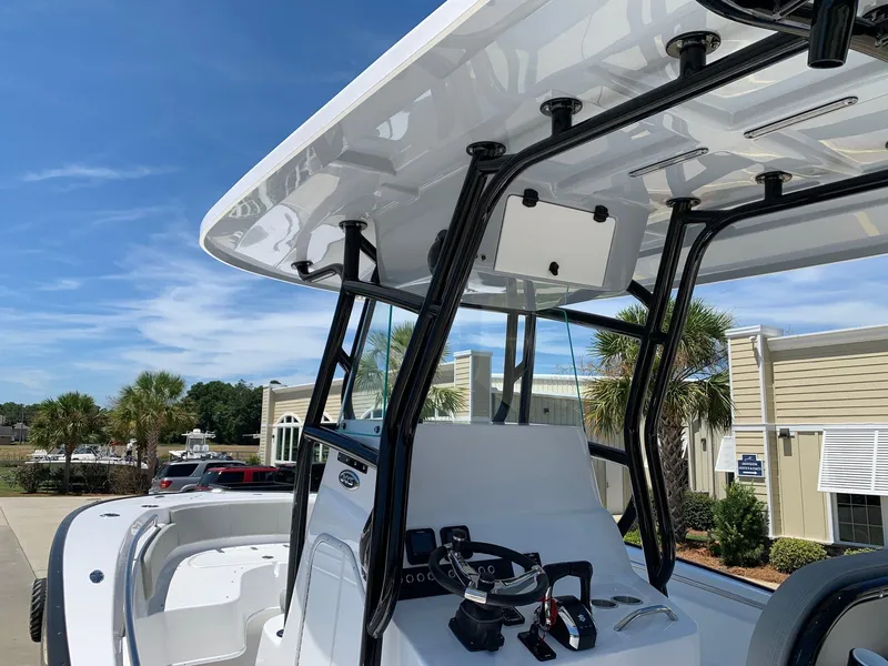 Slide: The Image of 2024 Cape Horn 24 XS boat with T-top and console, docked at marina. - 5