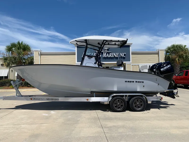 The Image of 2024 Cape Horn 24 XS boat on a trailer outside a marine dealership. - 0