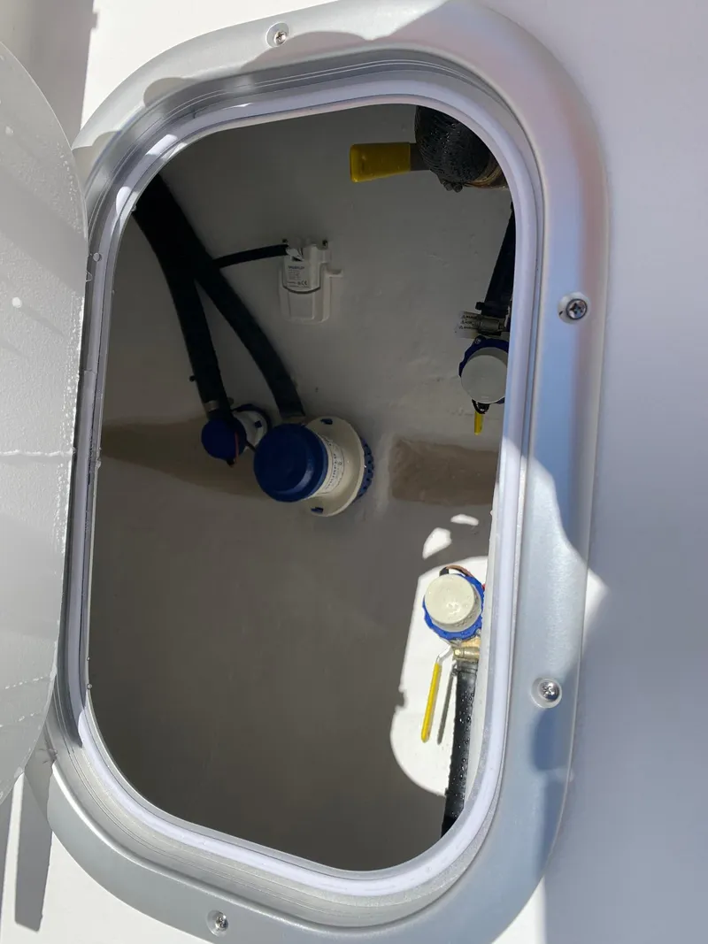Slide: The Image of 2024 Cape Horn 24 XS boat compartment with wiring and components. - 15