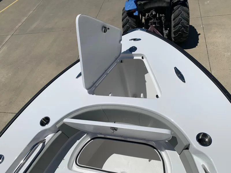 Slide: The Image of 2024 Cape Horn 24 XS boat with open storage compartments on deck. - 21