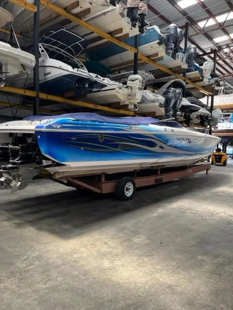 Slide: The Image of 2006 Donzi 43 ZR speedboat with blue and white design in storage facility. - 1