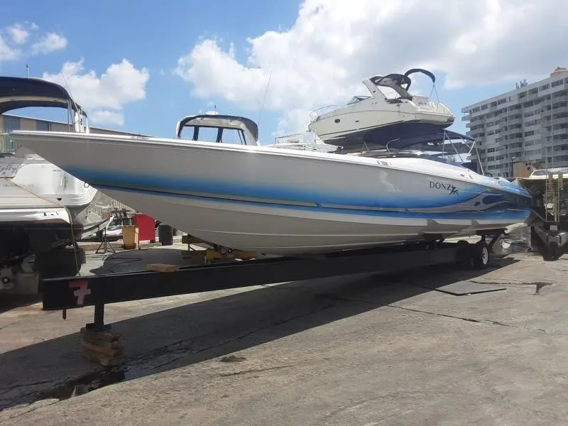 Slide: The Image of 2006 Donzi 43 ZR speedboat on trailer in marina. - 11