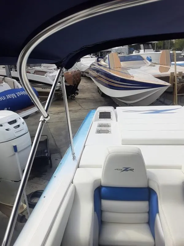 Slide: The Image of 2006 Donzi 43 ZR speedboat in a marina, surrounded by other boats. - 17
