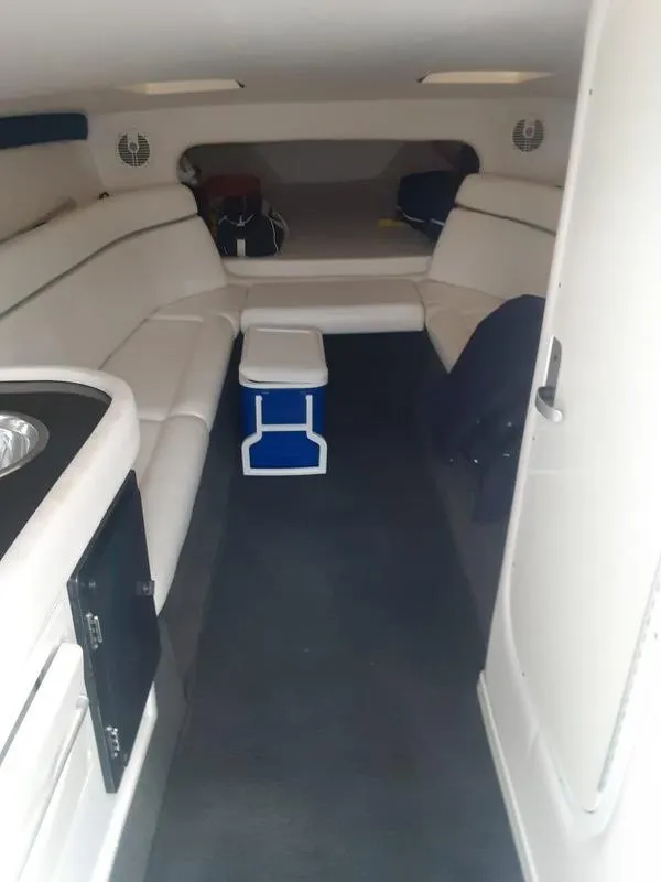 Slide: The Image of Interior cabin of a 2006 Donzi 43 ZR boat with white seating and a small table. - 18