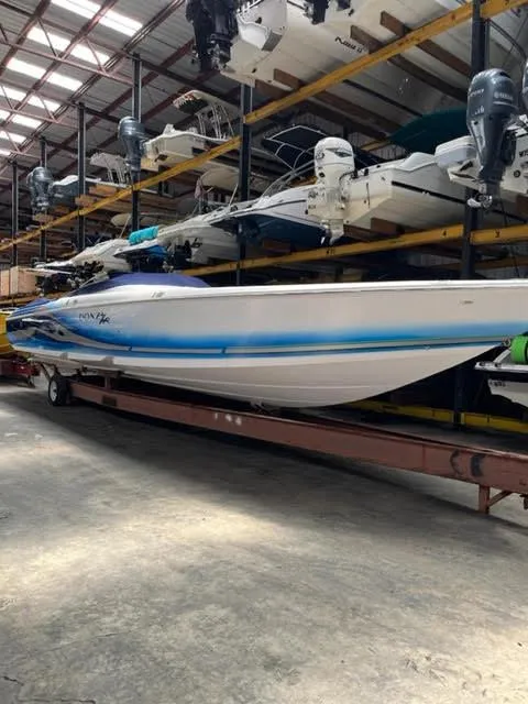 Slide: The Image of 2006 Donzi 43 ZR speedboat stored in a warehouse with other boats. - 2