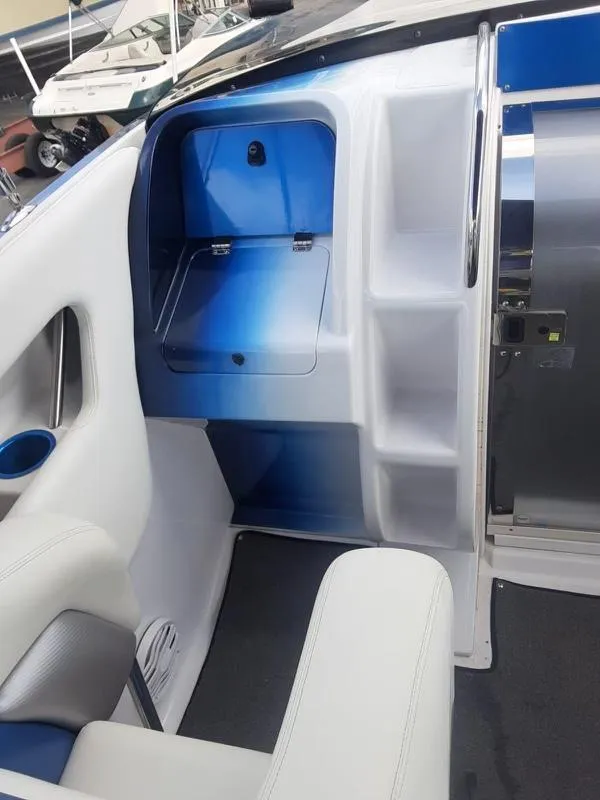 Slide: The Image of 2006 Donzi 43 ZR boat interior with blue and white seating and storage compartments. - 20