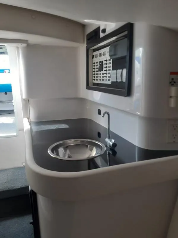 Slide: The Image of 2006 Donzi 43 ZR boat interior with modern kitchenette and sink. - 26