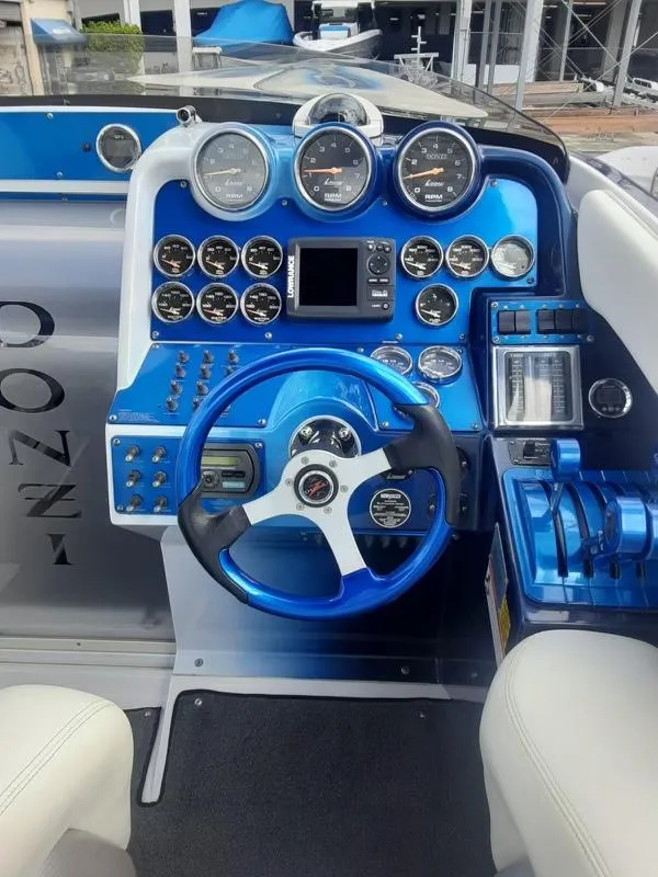 Slide: The Image of 2006 Donzi 43 ZR boat dashboard with blue accents and multiple gauges. - 27