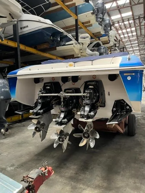 Slide: The Image of 2006 Donzi 43 ZR speedboat in storage, showcasing triple outboard engines. - 8