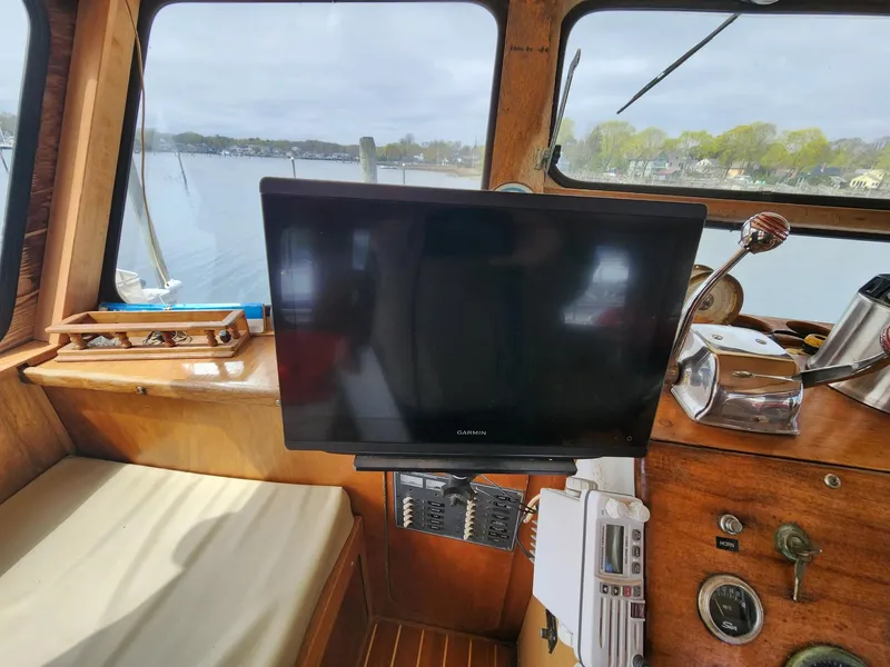 Slide: The Image of Interior of 1980 Tuna Rose Brothers boat with TV, wooden dashboard, and scenic window view. - 14