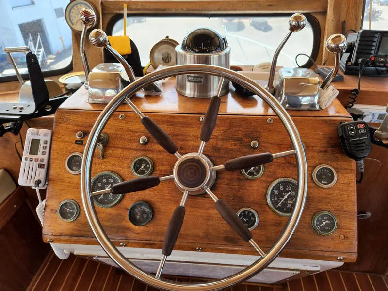 Slide: The Image of 1980 Tuna Rose Brothers boat helm with wooden dashboard and classic steering wheel. - 17