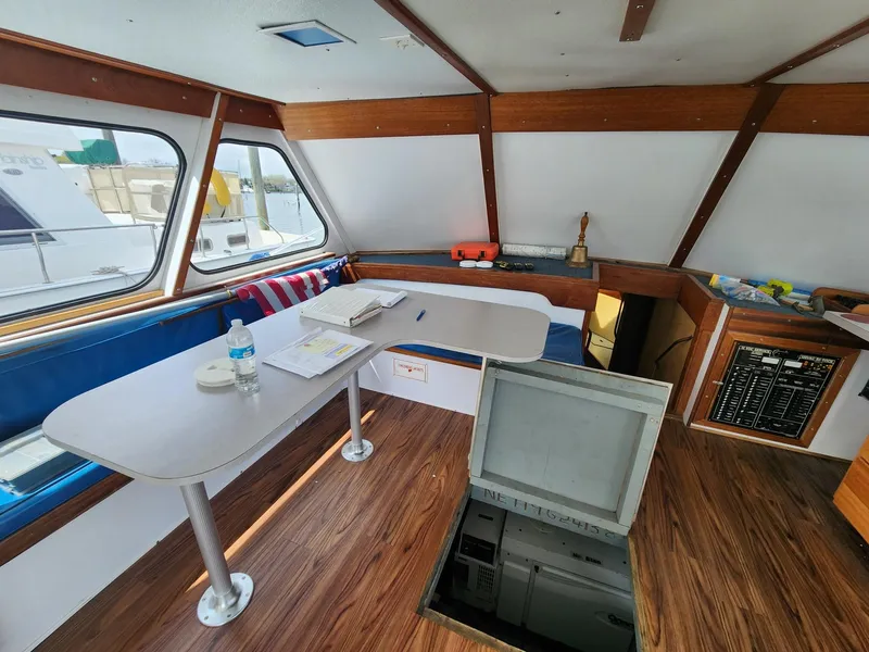 Slide: The Image of Interior of a 1980 Tuna Rose Brothers boat with wood accents and a table. - 20