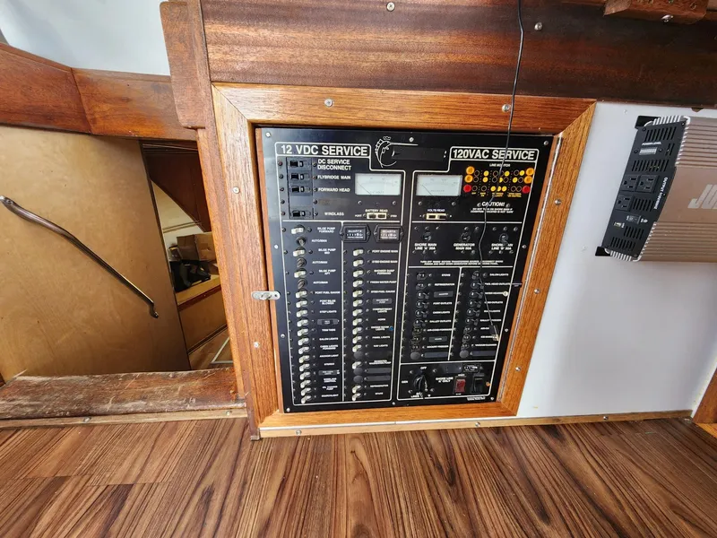 Slide: The Image of Electrical panel on a 1980 Tuna Rose Brothers boat, featuring 12VDC and 120VAC services. - 21