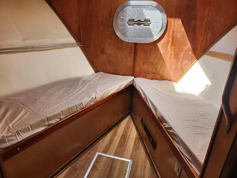 Slide: The Image of Cozy cabin interior of 1980 Tuna Rose Brothers boat with wooden finish and twin beds. - 23