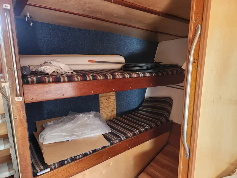 Slide: The Image of Bunk beds inside a 1980 Tuna Rose Brothers boat cabin with striped cushions. - 24