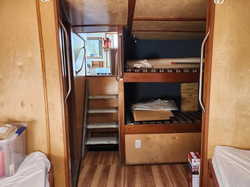 Slide: The Image of Interior of a 1980 Tuna Rose Brothers boat with wooden bunk beds and stairs. - 26