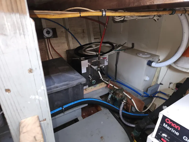 Slide: The Image of Engine room of a 1980 Tuna Rose Brothers boat with visible wiring and equipment. - 30