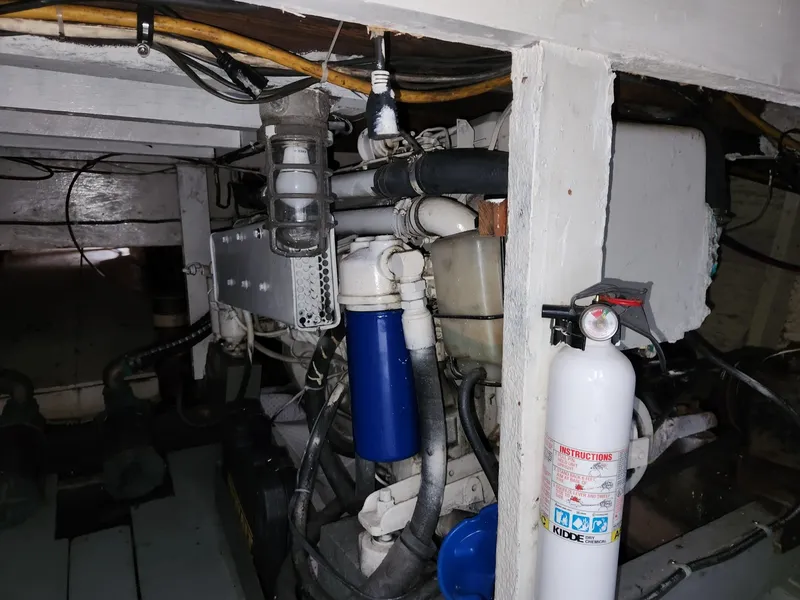 Slide: The Image of Engine room of a 1980 Tuna Rose Brothers boat, featuring equipment and fire extinguisher. - 31