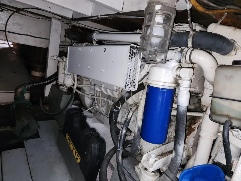 Slide: The Image of Engine room of a 1980 Tuna Rose Brothers boat, featuring various mechanical components and pipes. - 32