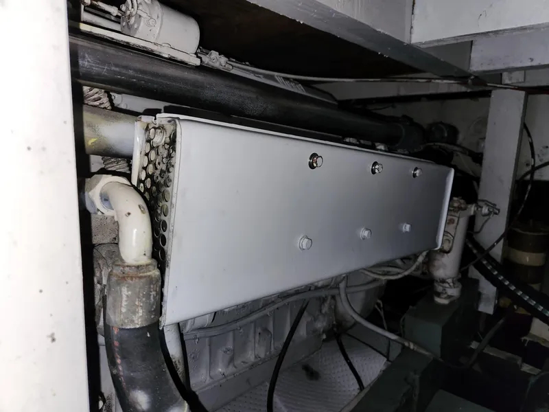 Slide: The Image of Engine compartment of a 1980 Tuna Rose Brothers boat, showing pipes and mechanical components. - 33