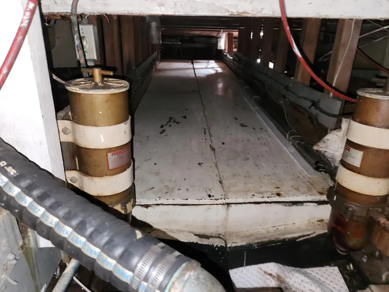 Slide: The Image of 1980 Tuna Rose Brothers engine room with visible machinery and wiring. - 34